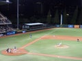 UH Pitcher Throws pitch to Air Force batter with ball in air during a night game Royalty Free Stock Photo