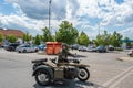 Ujezd nad Lesy, Czech Republic - June 01 2022: An elderly smiling European man rides a military tricycle, a military car