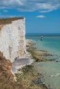 UK coastline blue sky and sea reflection with white cliffs and lighthouse Royalty Free Stock Photo