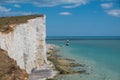 UK coastline blue sky and sea reflection with white cliffs and lighthouse