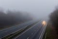 UK dual carriageway with little traffic in fog