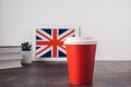 UK flag in the background, textbooks, a paper red cup with a hot drink, Royalty Free Stock Photo