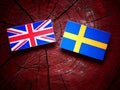 UK flag with Swedish flag on a tree stump Royalty Free Stock Photo