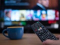 UK, Jan 2020: Netflix remote control with TV behind
