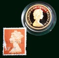 UK light brown stamp with portrait of Elizabeth II and 1980 Australian Gold sovereign on black background