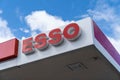An Esso Petrol Station logo with a blue sky and clouds in London