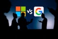 UK, LONDON. JANUARY 30, 2023: Microsoft vs Google. Innovating Together: Silhouetted Web Developers Uniting for Progress with