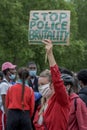 UK, London, 3/6/2020 - A young attractive blonde caucasian woman carrying a Stop police brutality placard at the Black Lives Matte