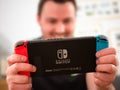 UK, March 2020: Nintendo Switch games console happy player enjoying gaming