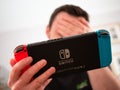 UK, March 2020: Nintendo Switch games console player losing disappointed with head in hands