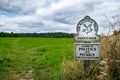 UK National Trust Sign on entrance to Runnymede meadow thousand year old picnic and polictic place, beautiful inviting plaque to Royalty Free Stock Photo