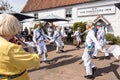 UK, Norfolk, Thornham, Chequers Inn, 2109, April, 22:. Morris Men, in white, gold and blue perform outside the Chequers Inn,