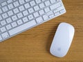UK, October 2019: Apple mac wireless mouse and keyboard on wooden desk Royalty Free Stock Photo