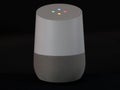 UK, October 2019: Google Home smart speaker illuminated on black background