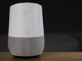 UK, October 2019: Google Home smart speaker on wooden table in lounge