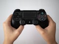 UK, October 2019: Sony Dualshock Playstation 4 games console controller remote being held over white background