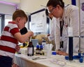 Laboratory chemists tak a day out of the lab to teach children about chemistry as part of the UK STEM, science, technology,engine Royalty Free Stock Photo