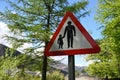 UK traffic sign for pedestrians with person holding hand of child