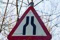 A UK Traffic sign stating road narrows ahead with a red and white warning triangle Royalty Free Stock Photo