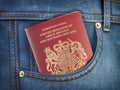 UK United Kingdom passport in pocket jeans. Travel, tourism, emigration and passport control concept