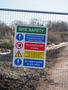 a close up of a site safety warning sign on a metal barrier