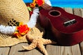 Ukelele and beach hat on dock Royalty Free Stock Photo