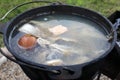 Ukha cooked from various fish in cauldron