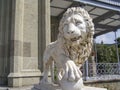 Paw and face of a marble lion, front view