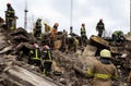 Firefighters work on the rescue of bodies in a building destroyed by a Russian shell