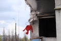 Ukraine, Borodyanka - 04.21.2022: A war-torn building and a red dress in the wind.