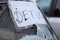 Ukraine, Bucha - 04.21.2022: A sheet of paper with the inscription `Children` on the shot glass of the car.