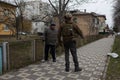 volunteer American soldier speaks with a Ukrainian senior