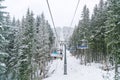 Ukraine, Bukovel - December 15, 2018. Lots of snowboarders and skiers lift to snow hill by elevator. Mountain ski spot in winter