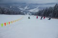 Ukraine. Bukovel - 02 FEBRUARY 2021. Skiers and curbs on the descent from the mountain and christmas trees. Part of the lift up