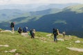 08.07.2021 Ukraine, Carpathians - Group of hikers with backpacks walks in mountains. Freedom, travel concept
