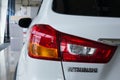 Rear light of a modern white car brand Mitsubishi. Close-up. Royalty Free Stock Photo