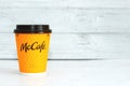 Ukraine, Cherkasy May 16, 2021 - Yellow glass with coffee from McDonald`s on a light background.