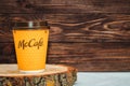 Ukraine, Cherkasy May 16, 2021 - Yellow glass with coffee from McDonald`s on a wooden background.