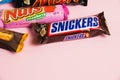 Ukraine, Chernihiv, April 26, 2023: Snickers bar close-up, chocolate bars on pink paper background