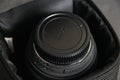 Ukraine, Chernihiv, February 21, 2023 : old Sigma lens with dust and scratches in a black branded case on a gray background