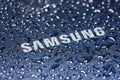 UKRAINE, DNEPR - AUGUST 25, 2022: Samsung company logo. Water drops on Samsung logo Royalty Free Stock Photo