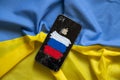 Ukraine Dnepr 09.03.2022 - Broken apple iPhone 4 with a painted Russian flag on the background of the flag of Ukraine, sanctions