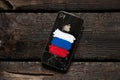 Ukraine Dnepr 07.03.2022 - Broken apple iPhone 4 with a painted Russian flag, sanctions in Russia, Russia`s war against Ukraine,