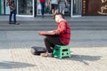 Ukraine Dnepr 10.07.2021 - A street musician plays a guitar on the street in the city center in summer