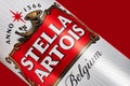 Ukraine. Dnipro. 20 march 2023: Can of Stella Artois beer on beer barrel with red background