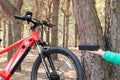 Ukraine Dnipro 05.04.2021 - a red electric bike is recharged in a forest in a park, new technologies