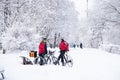 Ukraine Dnipro 26.12.2021 - three couriers with bicycles from the delivery company rocket stand in a winter park on vacation,