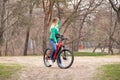 Ukraine Dnipro 08.04.2021 - a young girl rides a red electric bike in the park