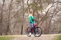 Ukraine Dnipro 08.04.2021 - a young girl rides a red electric bike in the park