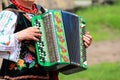 Ukraine. An elderly woman in the Ukrainian costume plays the accordion at the ethnic festival in Petrikovka Royalty Free Stock Photo